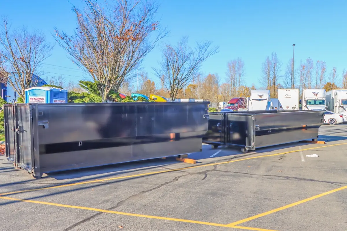 Professional dumpster rental service with roll-off container on residential driveway in Belle Chasse